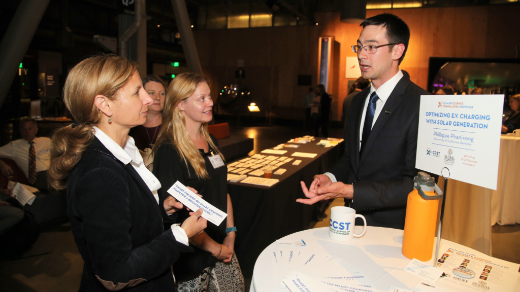 UC Berkeley doctoral student Phillippe Phanivong explains his research on optimizing solar energy grid production with electric vehicle charging times to guests at the OPR "Celebration of Science and Education" reception.  The California Council on Science and Technology (CCST) hosted the CCST Climate Science Translators Showcase on Tuesday, September 11, 2018 at the Exploratorium as an Affiliate Event of the historic Global Climate Action Summit in San Francisco — held during the "Celebration of Science and Education" reception hosted by the Governor's Office of Planning and Research (OPR), CCST, the Gordon and Betty Moore Foundation, CalEPA, and Ten Strands. The #CCSTShowcase recruited and trained 12 graduate students and postdocs from California universities and research institutions to communicate their climate-related research to policy leaders, staff, and other Summit delegates.