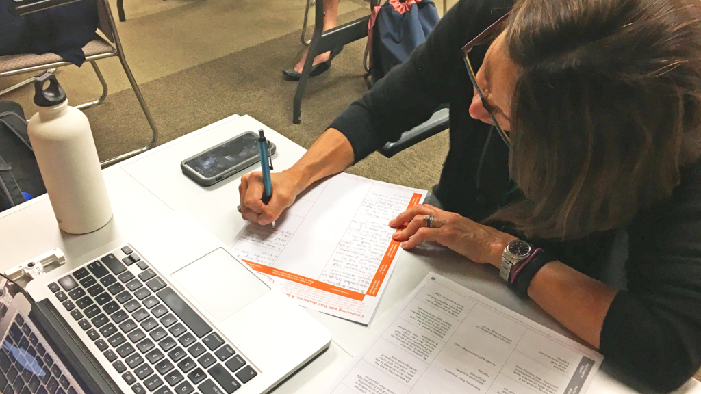 A scene from a "Connecting with Your Audience" Workshop taught by Ben Young Landis for the NorCal SETAC Annual Meeting. Here, a workshop participant is filling out the Connecting with Your Audience worksheet.