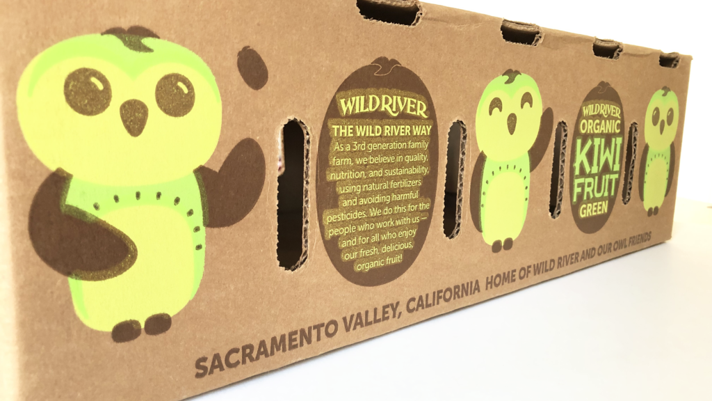 Our Owl Friends and associated kiwi owl logos are trademarks of Wild River Marketing Inc. Designed by Ben Young Landis and Guy Rogers. The photo shows a volume-fill carton for Wild River kiwifruit. Amid a row of green kiwi owls, the text reads: The Wild River Way: As a third generation family farm, we believe in quality, nutrition, and sustainability, using natural fertilizers and avoiding harmful pesticides. We do this for the people who work with us — and for all who enjoy our fresh, delicious, organic fruit!