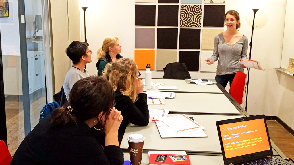 A scene from a "Connecting with Your Audience" Workshop taught by Ben Young Landis. Here, UC Davis astrophysics researcher Victoria Strait practices her 60-second science communication briefing.