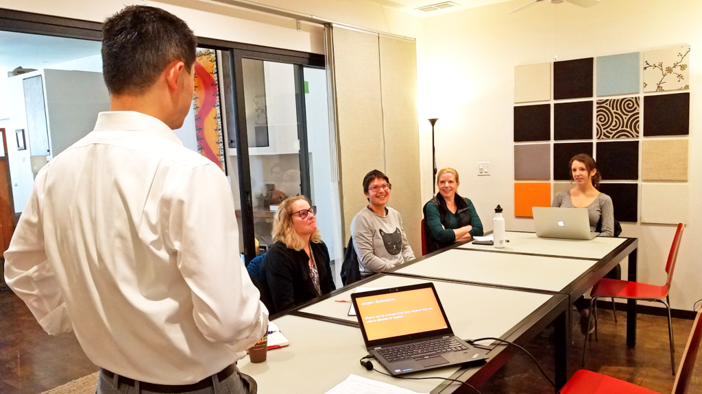 A scene from a "Connecting with Your Audience" Workshop taught by Ben Young Landis. Here, Ben Young Landis asks the audience for examples of jargon from different fields of research.